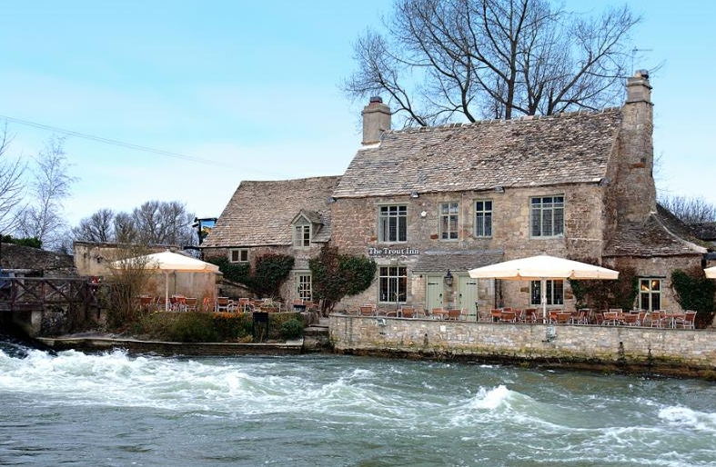 Riverside views of The Trout Inn on the Upper Thames in the Cotswolds, Oxfordshire